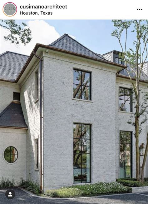 Large White Brick House with Abundant Windows