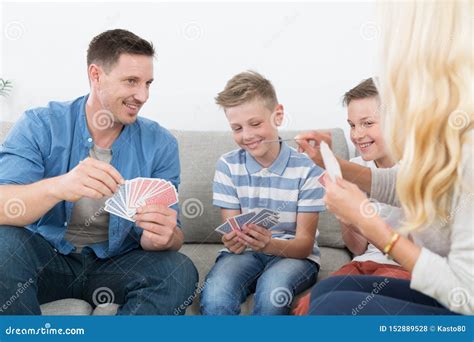 Happy Young Family Playing Card Game at Home. Stock Photo - Image of ...