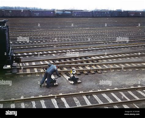 Switchman throwing a switch at Chicago and North Western Railroad's Proviso Yard, Chicago ...