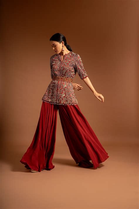 Red embroidered ajarkh peplum top with flare pants and embroidered wai