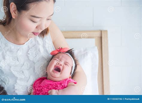 Newborn Crying while Mother Holding in Bedroom Stock Photo - Image of ...