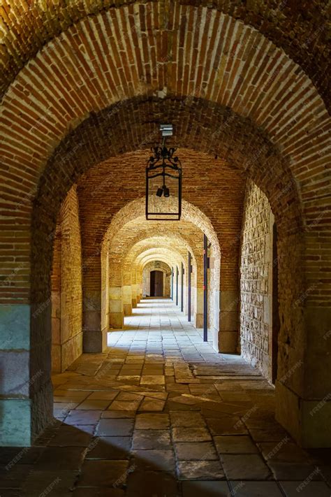 Premium Photo | Brick arches in the passages of the castle of Montjuic ...