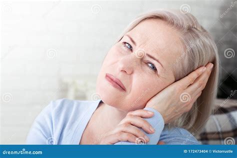 Tinnitus. Closeup Up Side Profile Sick Female Having Ear Pain Touching Her Painful Head Stock ...