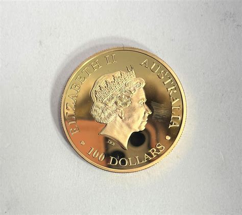 Lot - A Reproduction Australian Gold Plated 100 Dollar Coin with ...