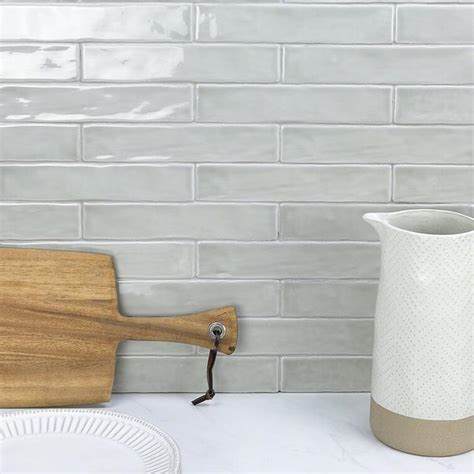 Subtle Harmony: Uneven Light-Textured Tiles with Ivory Countertop