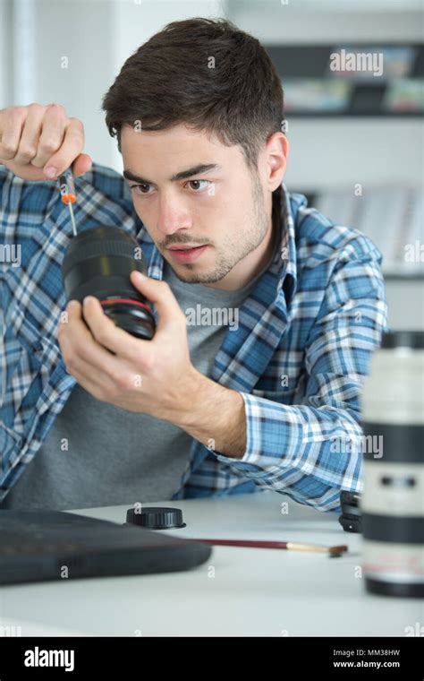 disassembling the camera lens Stock Photo - Alamy
