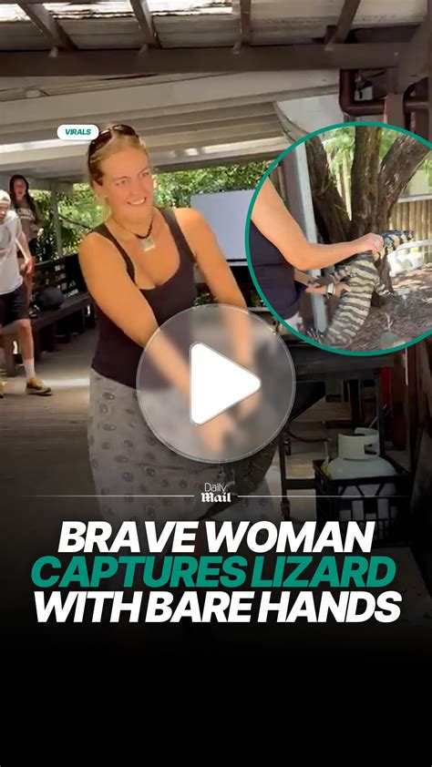 Woman captures large lizard with her bare hands