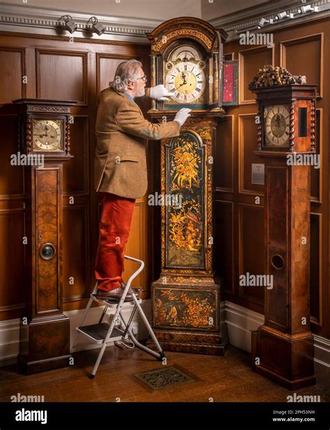 President of the British Horological Institute Alan Midleton, adjusts ...