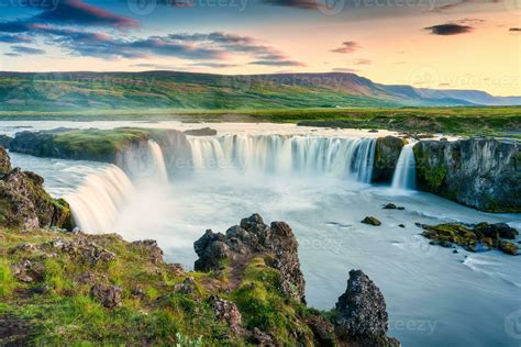 Godafoss waterfall flowing with colorful sunset sky in summer at ...