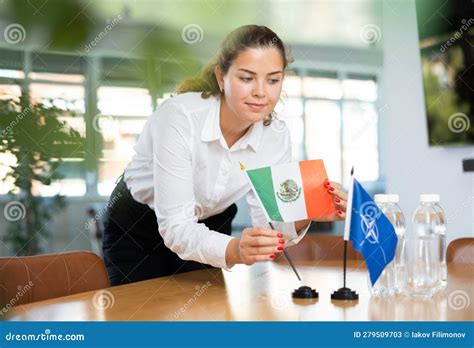 Young Female Secretary Preparing Room for International Negotiations between Nato and Mexico ...