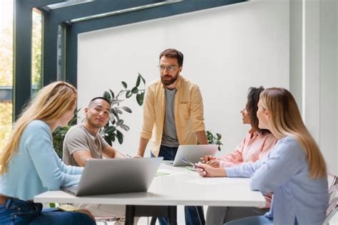 People working in tech brand together | Free Photo