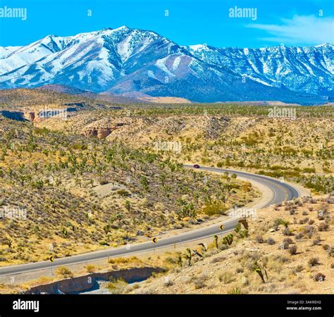Aerial of Desert Road and Snow-Capped Mountains in Nevada Stock Photo ...