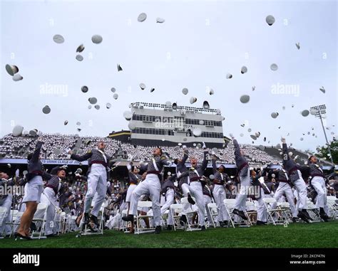 West Point graduates toss their hats in the air after the conclusion of ...