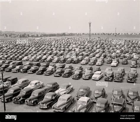 1940s 1950s HUNDREDS OF AUTOMOBILES ALIGNED TOGETHER IN MUNICIPAL COMMUTER PARKING LOT FLUSHING ...