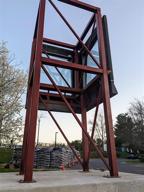 2-sided metal and glass structure (no roof or floor), about 20 feet ...