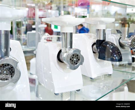 Electric meat grinders in the store Stock Photo - Alamy