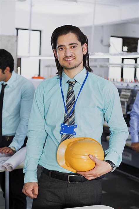 Adult-man Engineer Holding Safety Helmet Standing in-Clothing Factory