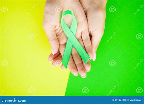 Green Ribbon in Hand As a Symbol To Awareness Lymphoma Cancer Stock ...