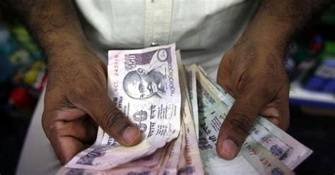 Rupee slips 5 paise to close at 67.11/USD - Rediff.com Business