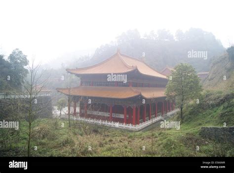 Photo of an elaborate Chinese temple with hedges in front.