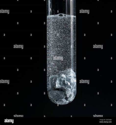 Zinc reacting with a strong acid. The reaction is vigorous, shown by ...