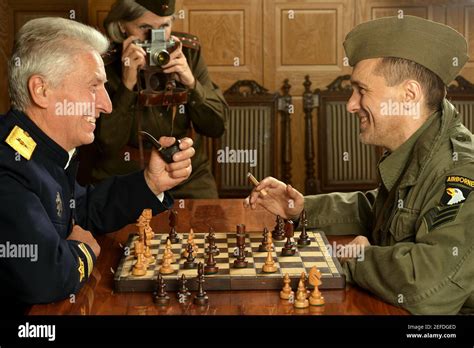 Military mature general on the table playing chess with soldier Stock ...