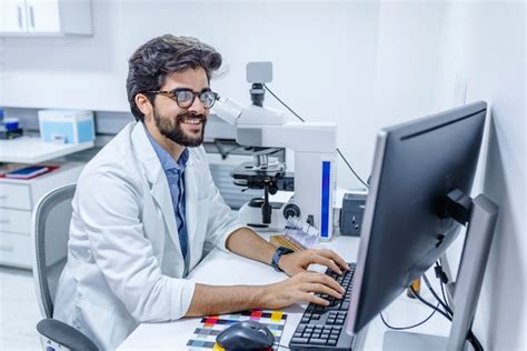 Doctor typing on his computer in the office | Premium Photo