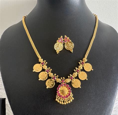 Gold tone pink stone lakshmi coin necklace set dj-48025 – dreamjwell