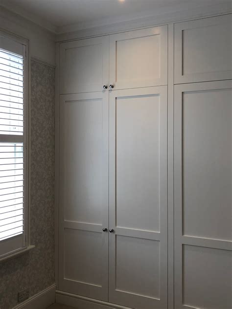 Bespoke fitted wardrobes, installed floor-to-ceiling along one wall of ...