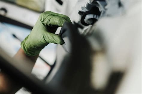 Female mechanic pulling out the weather seal of a vehicle | Premium Photo