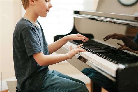 "Child Playing Piano" by Stocksy Contributor "Kelly Knox" - Stocksy