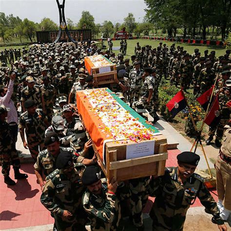 Indian Border Security Force (BSF) officers carry the coffins ...