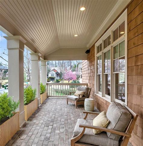 Covered front porch with seating, cedar shake siding, brick floors ...