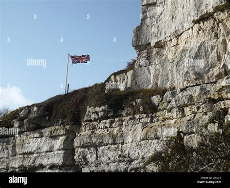 Rock face of Portland stone - union Jack flag flying above Stock Photo ...