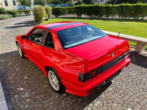 Download Red Maserati Shamal Parked Outdoors Wallpaper | Wallpapers.com
