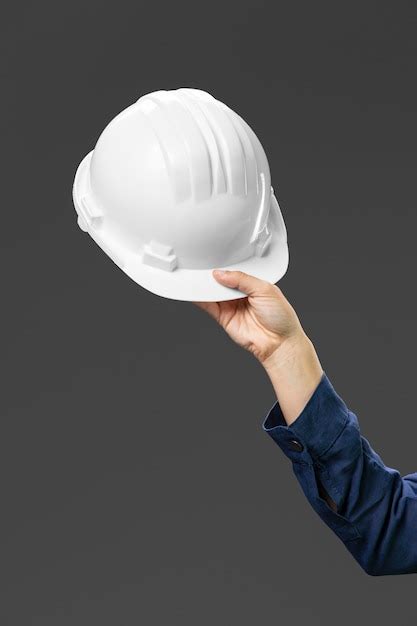 Portrait female engineer holding helmet close up | Free Photo