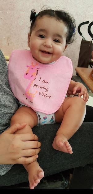 Portrait of smiling cute smiling baby sitting on father lap | Premium Photo