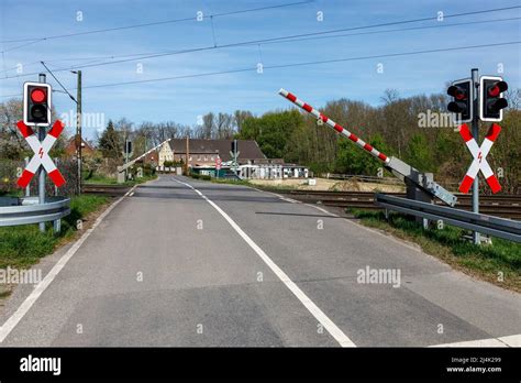 Closing barriers at the level crossing Stock Photo - Alamy