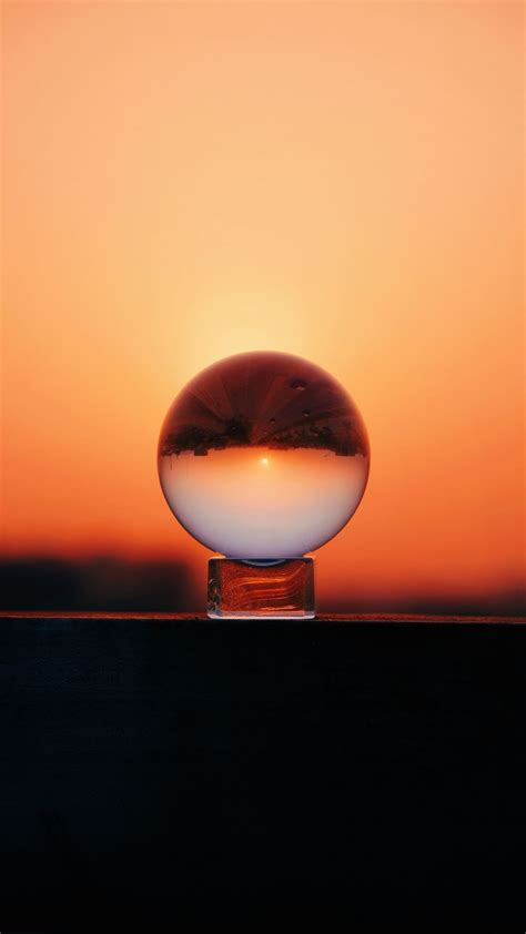 Download wallpaper 938x1668 ball, glass, sunset, reflection, sky, macro ...
