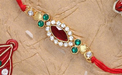 LIVE EVIL Enticing Gold plated Stone Work Rakhi for Brother Sister with ...