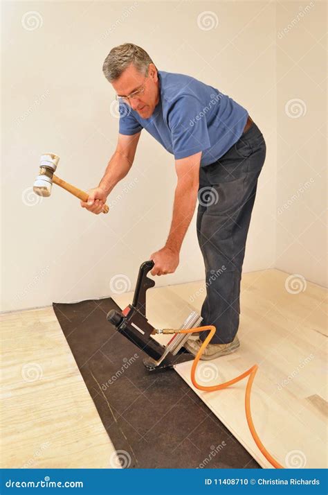 Man Installing Hardwood Floor Using Nailer Stock Photo - Image of ...