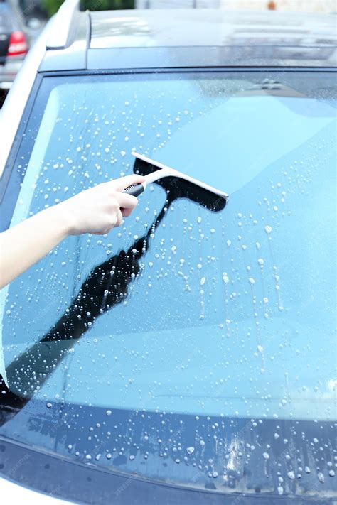 Premium Photo | Hand washing car window