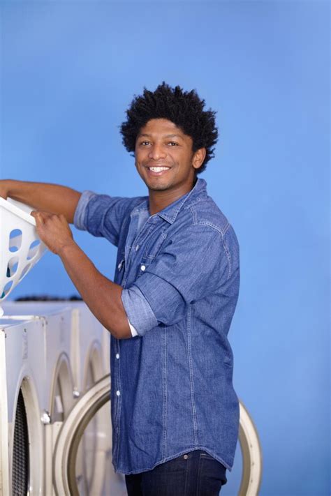 Laundry portrait of a black man at washing machine and basket at ...