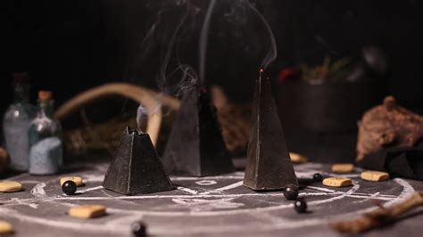 Black magic candles burn. Smoke on the background of the magical ...