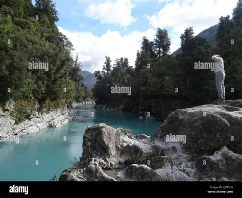 The Hokitika Gorge in New Zealand with a man standing on the edge of ...