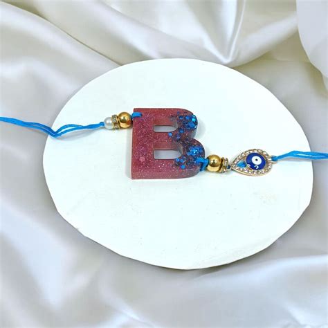 Send Monogrammed Resin Rakhi Charm Online