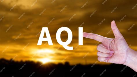 Premium Photo | AQI Abbreviation of air quality index hand holding AQI on nature background ...