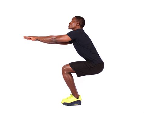 Muscular Man Doing Air Squats Exercise - High Quality Free Stock Images