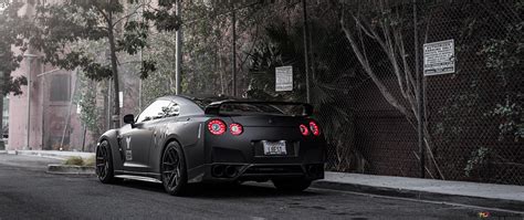 Black Nissan GT-R on forest road 4K wallpaper download