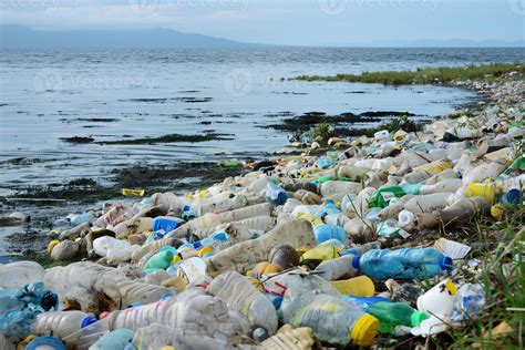 A beach littered with plastic trash, polluting the ocean and harming ...